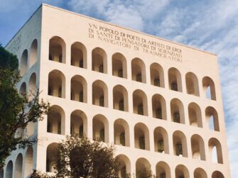 Palazzo della Civiltà Italiana, Rome, featuring arched windows and inscription: 